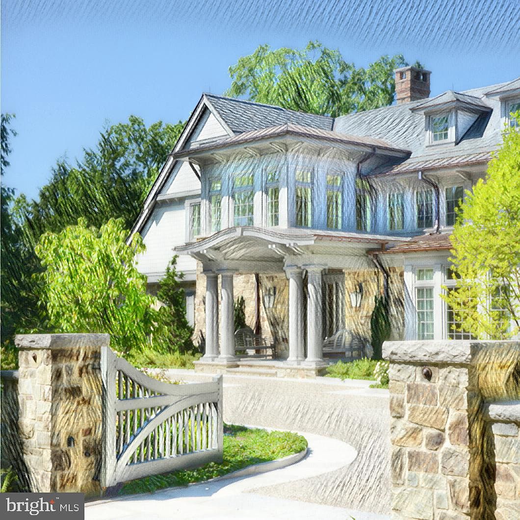 Three-quarter view of a stone-and-shingle estate home behind stone gate posts, a completed Polo Design Build project
