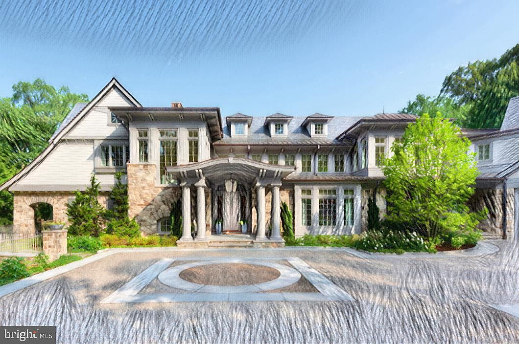Front elevation of a stone-and-shingle Polo Design Build estate home framed by tall trees under a clear sky
